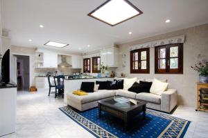 a living room with a couch and a table at Mas Llavaneres in Sant Andreu de Llavaneres
