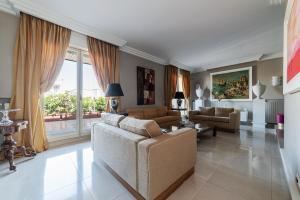 a living room with two couches and a large window at HOME TAWN Luxury Apartment Bari in Bari