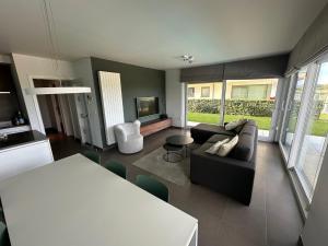 a living room with a couch and a table at Villa Moya in Nieuwpoort