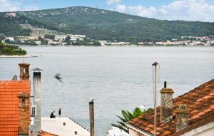 a bird flying over a large body of water at Stunning Apartment In Biograd With Wifi in Biograd na Moru +15 photos