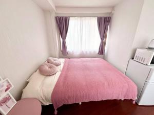 Cama ou camas em um quarto em 要町3階駅10秒出張や長期滞在にもおすすめ池袋駅から1駅可愛いピンクのお部屋