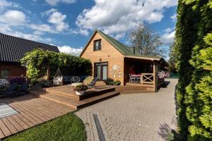 a home with a deck and a house at Zielono mi in Trześcianka