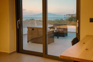 a sliding glass door with a view of a balcony at Seaview Villa Volter by "elite" in Kipseli