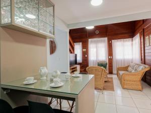 a kitchen and living room with a table and chairs at Casa c/ piscina privativa a 150m da praia PU9263 in Itajubá