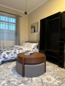 a living room with a bed and a coffee table at Boston Apartments Dodoma in Dodoma +6 photos