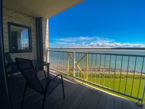 einen Balkon mit einem Tisch und Strandblick in der Unterkunft Hello Zeeland - Appartement Port Scaldis 19-042 in Breskens