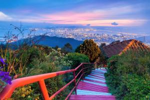 a set of stairs with a view of a city at Kek Lok Si Inn in Ayer Itam
