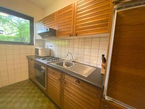 a kitchen with a sink and a stove at Hello Zeeland - Vakantiehuis Het Heem 39 in Breskens