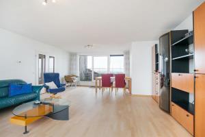 a living room with a couch and a table at Hello Zeeland - Appartement Port Scaldis 13-112 in Breskens