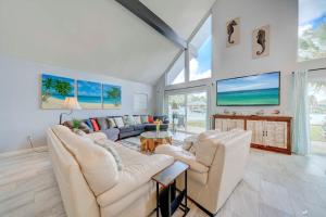 a living room with two couches and a fireplace at Dolphin Days Lagoon Retreat in Panama City Beach