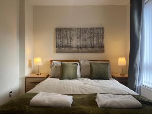 a bedroom with a bed with two pillows on it at The Nest in Belfast
