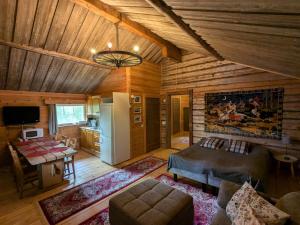 a large living room with a refrigerator and a kitchen at Santa's Little Village - Hotel Uitonniemi in Kemijärvi