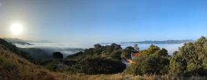 a view of a foggy valley with the sun in the background at Casa KiSi Cottage, Rural Boutique Bed & Breakfast in Málaga