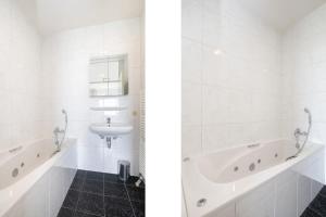 a white bathroom with a sink and a tub at Hello Zeeland - Appartement Port Scaldis 11-112 in Breskens