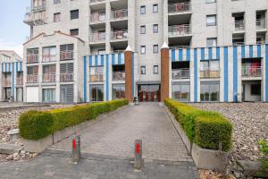 a brick walkway in front of a large building at Hello Zeeland - Appartement Port Scaldis 11-112 in Breskens