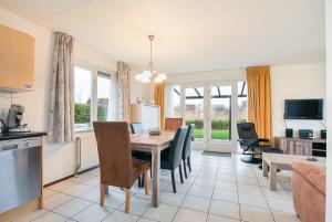 a kitchen and dining room with a table and chairs at Hello Zeeland - Vakantiehuis Schelde 194 in Breskens