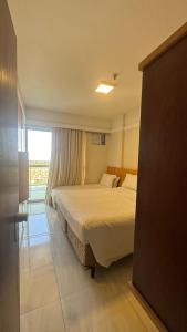 a hotel room with a bed and a window at MANHATTAN - JK APART Hotel in Brasilia +3 photos