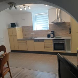 a kitchen with a sink and a stove top oven at FeWo PAN in Pfarrkirchen