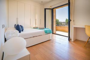 a bedroom with a bed and a view of a balcony at Campos -2795-31 Mallorca in Campos +68 photos
