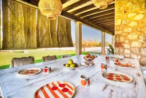 a wooden table with plates of food on it at Campos -2795-31 Mallorca in Campos