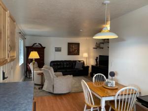 a living room with a table and a couch at Zion Cottage Glendale in Glendale