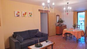a living room with a couch and a table at Le Mas Des Ferrayes in Ongles +30 photos