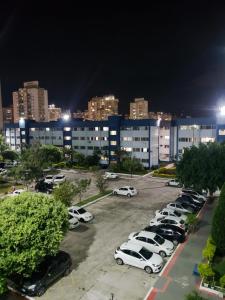a parking lot with cars parked in front of a building at Apartamento Praia Coqueiral de Itaparica - Vila Velha in Vila Velha +19 photos