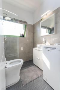 a bathroom with a toilet and a sink at Horizon View in Romanós +19 photos