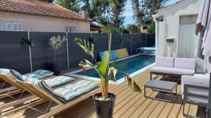a backyard deck with a pool and a chair and a couch at Villa Vacances avec piscine Côte d'Azur in La Londe-les-Maures