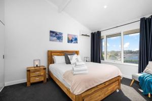 a bedroom with a large bed and a window at Belmont 3BR Townhome by Short and Long Stays in Belmont
