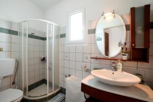 a bathroom with a sink and a toilet and a mirror at Gialiskari Studios in Gialiskari +28 photos