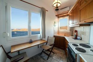 a kitchen with a table and two chairs and a window at Gialiskari Studios in Gialiskari