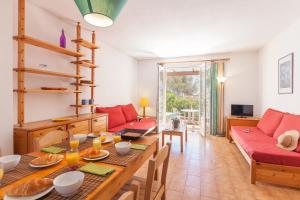 a living room with a table and a couch at Résidence Partenaire Le domaine de Garlande in Cavalaire-sur-Mer