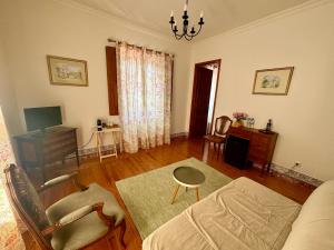 a living room with a couch and a table at Casa da Villa 1B in Sintra