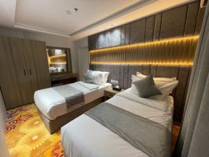 a hotel room with two beds and avisor at Sweet Land Hotel in Umm Lujj +34 photos