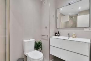 a bathroom with a toilet and a sink and a mirror at Lujoso estudio cerca del mar en Marbella centro - MARINO II 111 in Marbella +26 photos