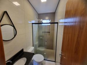 a bathroom with a shower and a toilet and a mirror at 1- ACHEI Casa - Seu espaço preferido em Porto Velho in Porto Velho +37 photos