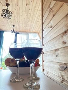 two glasses of blue wine sitting on a table at Demetra in Buknari +6 photos