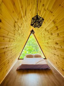 a bedroom in a tree house with a window at Demetra in Buknari