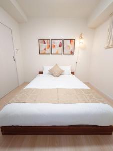 Postel nebo postele na pokoji v ubytování Neighbor's Hotel 十日市