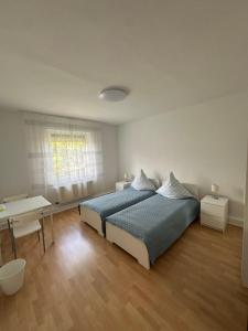 デュースブルクにあるPrivatzimmer am Iltisparkのベッドと机のある白い寝室