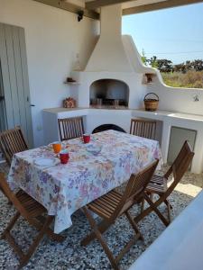 a kitchen with a table with chairs and a stove at Gardenparadise Sifnaios in Paros in Kampos Paros