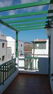 a balcony with a green roof with a view at famarabeach2 in Famara