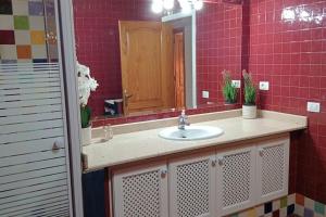 a bathroom with a sink and a mirror at famarabeach2 in Famara