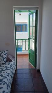 a room with a door leading to a room with a bed at famarabeach2 in Famara