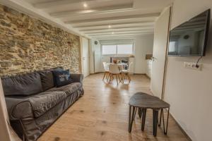 a living room with a couch and a table at Grange Rénovée 3 pers-Le GrandLieu-Gîte Le 411 in Saint-Philbert-de-Grand-Lieu