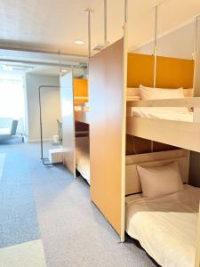 a room with two bunk beds and a room with a room at ROSE ROOM in Fukuyama