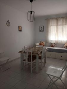 a living room with a table and a couch at Alojamiento Casa Male in Algodonales