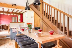 a kitchen with a wooden table with chairs and stairs at Gite Nature Loire et Châteaux 3* in Villandry