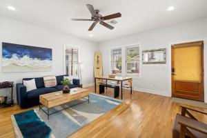 a living room with a couch and a table at NEW! Casa Fuente - Beautifully Renovated Ybor Bungalow, Steps to 7th Ave in Tampa